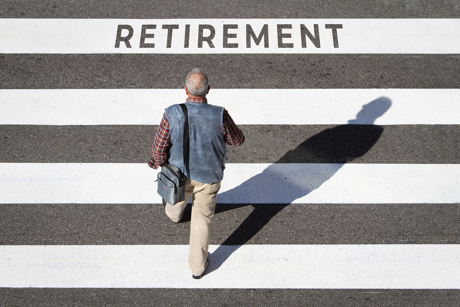 Aging truck driver crossing the road to retirement.